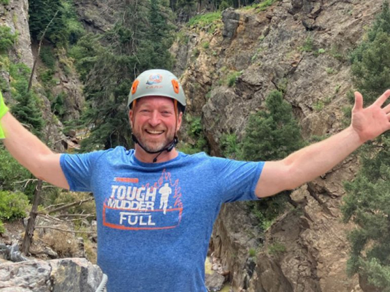 Man celebrates outdoor adventure in rugged terrain