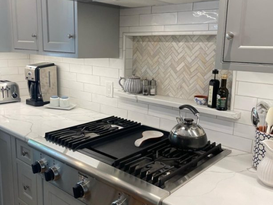 Contemporary kitchen design with sleek appliances and white cabinetry