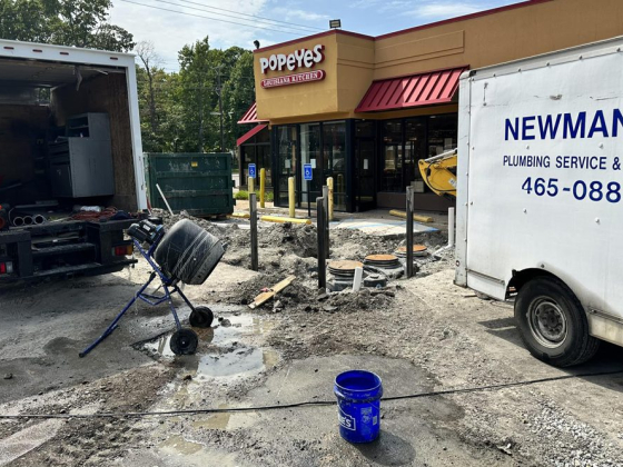 Plumbing service truck parked near construction site