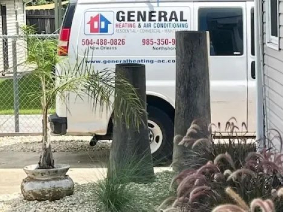 Heating and air conditioning van beside landscaped garden