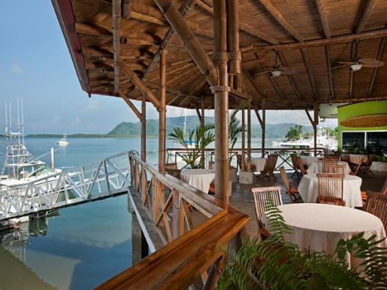 Outdoor dining area overlooking a calm waterfront scene