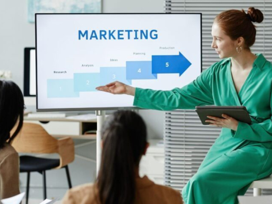 Speaker discusses marketing steps with audience