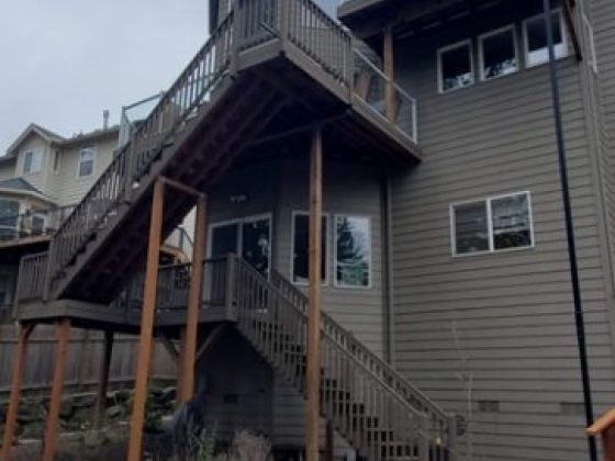 Backyard view with patio furniture and stairs