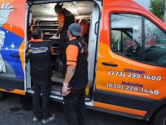 Three workers in plumbing van checking supplies