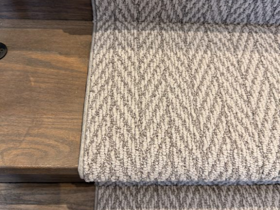 Textured carpet runner on wooden stairs