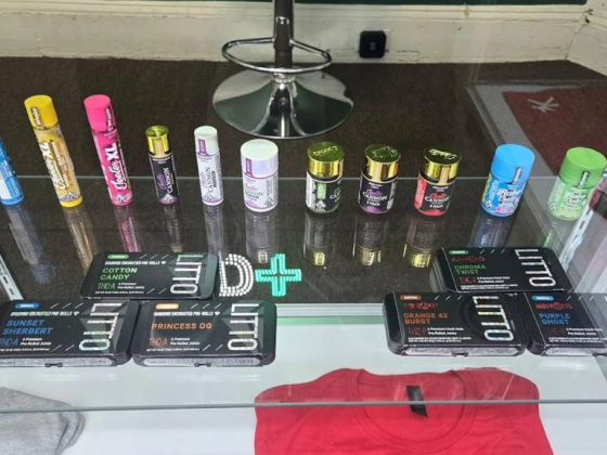 Variety of vape products and containers arranged on a shelf