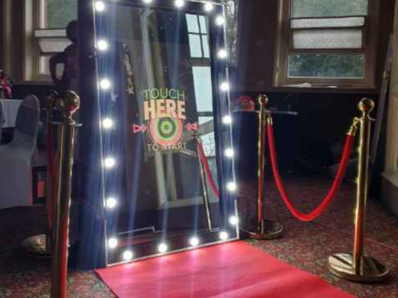 Touch-activated mirror booth setup at an event