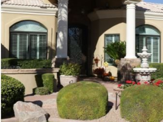 A beautiful home with columns and well-kept landscaping