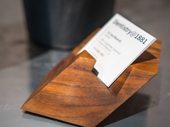 Sleek wooden holder displaying a business card
