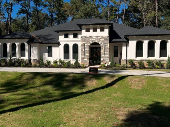 Elegant house surrounded by trees and green lawn