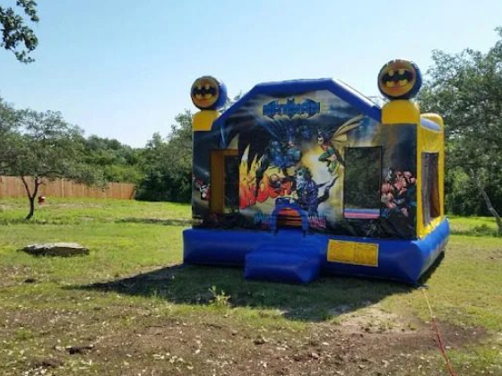 Colorful bounce house with Batman design outdoors