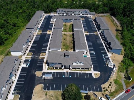 Aerial shot of a modern residential complex with empty parking spaces