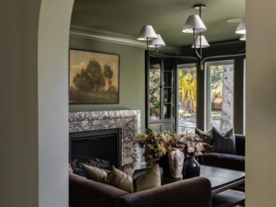 Cozy living room with sofas and fireplace through archway