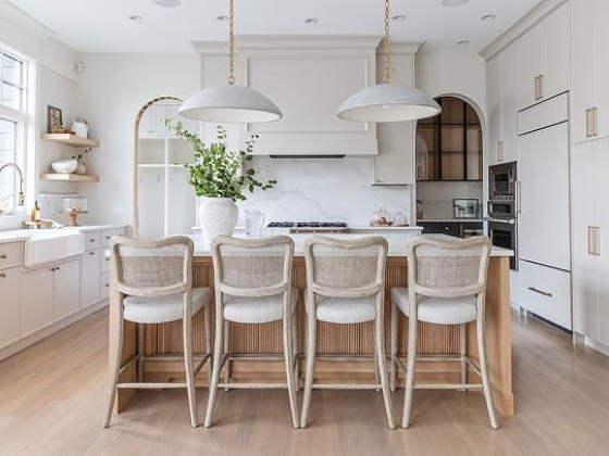 Stylish kitchen featuring island, seating, and white cabinetry