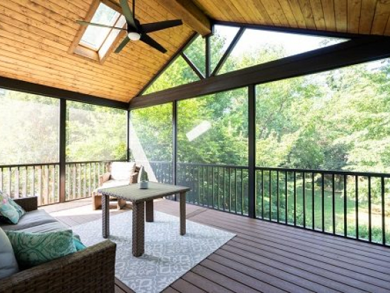 Screened porch overlooking lush green garden