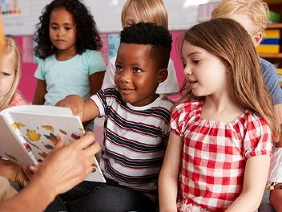 Kids eagerly listen to a story being read aloud