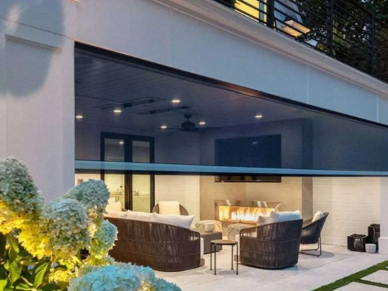 Modern patio area with cozy chairs and fireplace