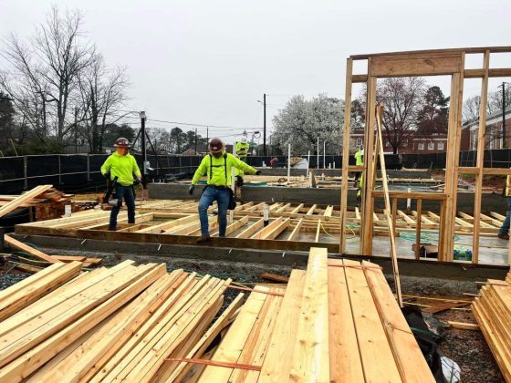Workers building framework at construction site
