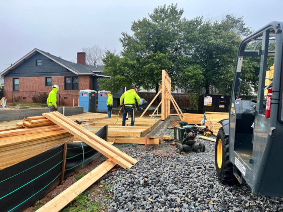 Workers assembling wooden frames on a building site