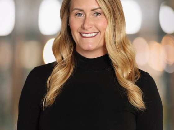 Portrait of a woman smiling against blurred background