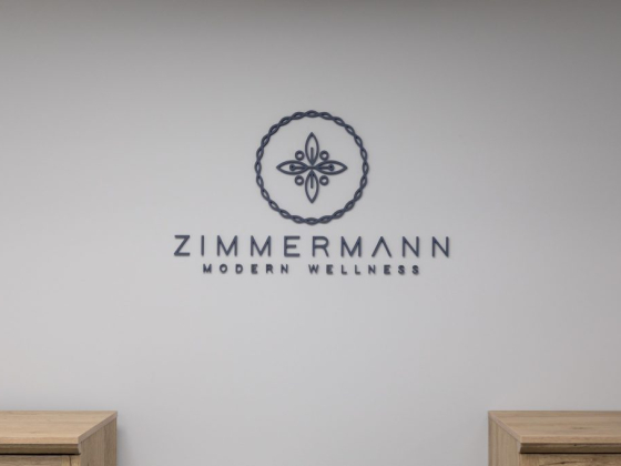 Minimalist logo with floral design on white wall