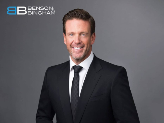Man in suit with Benson & Bingham logo in top left