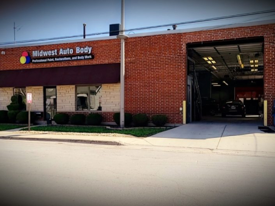 Midwest Auto Body shop showing entrance and open garage bay