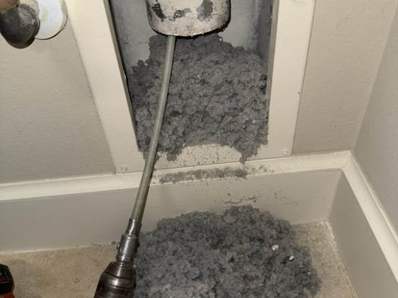 Lint removed from dryer vent using a cleaning tool