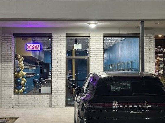 A Porsche parked outside Farjē Perfumes store