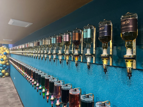 Various bottled drinks displayed on a blue wall