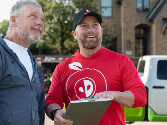 Men holding clipboard for business talk outside