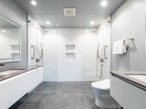 Contemporary bathroom featuring sleek dual sinks and spacious walk-in shower
