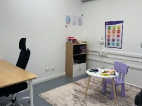 Office space featuring a desk and colorful children's table.