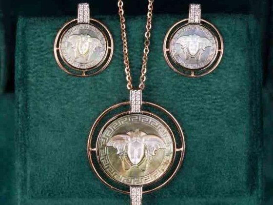 Gold and diamond jewelry set with intricate ram design