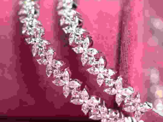 Close-up of a sparkling diamond bracelet on pink background