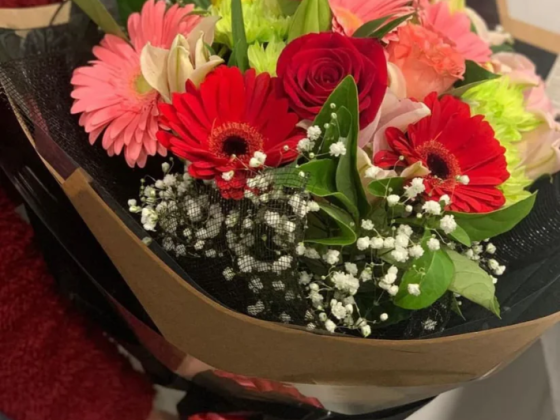 A vibrant flower bouquet with red and pink flowers