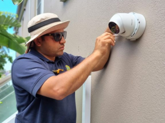 Technician adjusts outdoor security camera