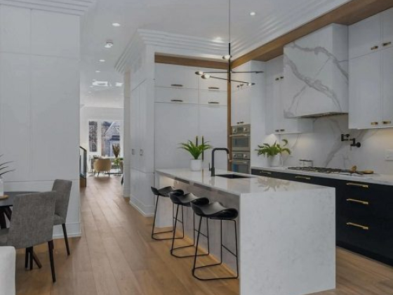 Sleek kitchen features marble accents and stylish seating