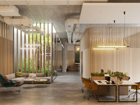 Stylish office area featuring seating and workstations with greenery