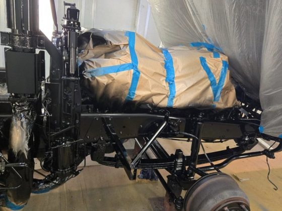 Engine wrapped in paper and tape on vehicle chassis