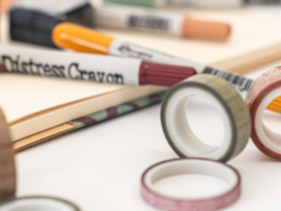 Craft supplies including crayons and decorative tapes