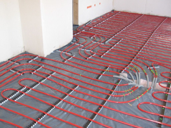 Underfloor heating system with red pipes laid out
