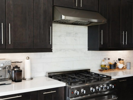Sleek kitchen setup featuring a stove and espresso machine