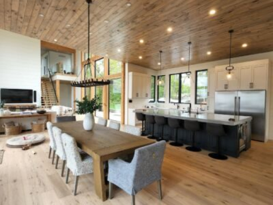 Spacious kitchen and living area with wooden ceiling and flooring