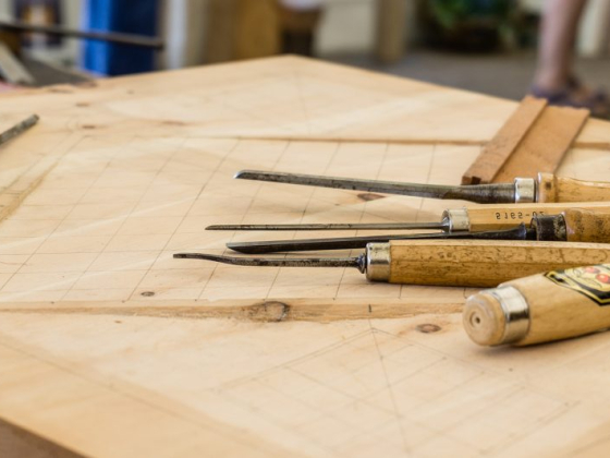 Chisels and gouges arranged on a craftsman's workbench