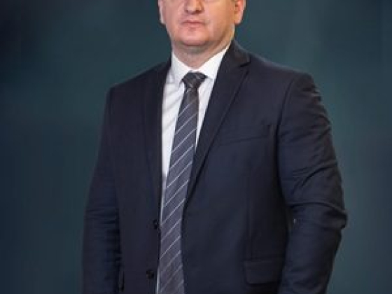 Man in formal attire posing confidently