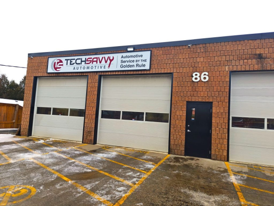 Brick automotive service building with signage and three doors