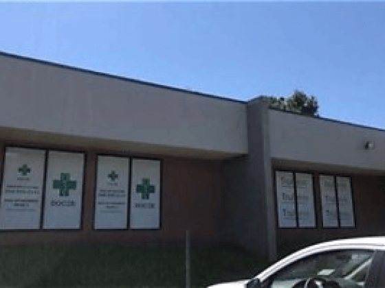 Medical clinic entrance with green cross symbols on windows