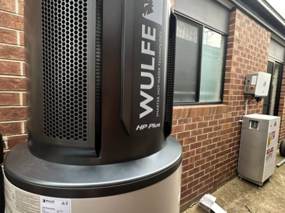 Modern Wulfe hot water system beside brick exterior and windows