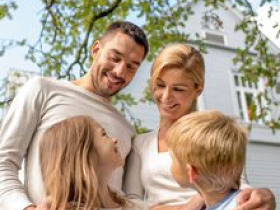 Happy family bonding in front of a house